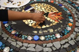 Students working on mosaics